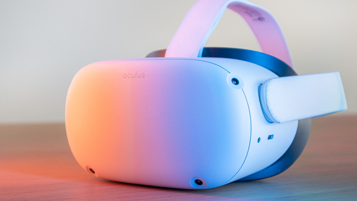 VR headset with soft rim lighting in a futuristic workspace.